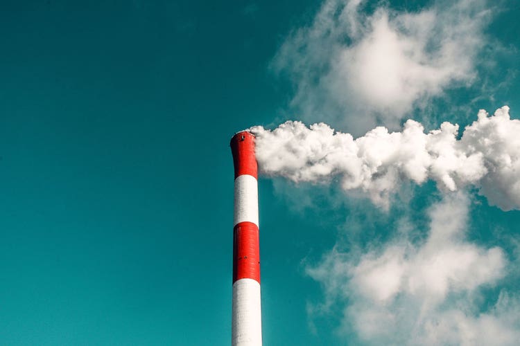 photo of factory plant chimney, representing Regulatory Compliance