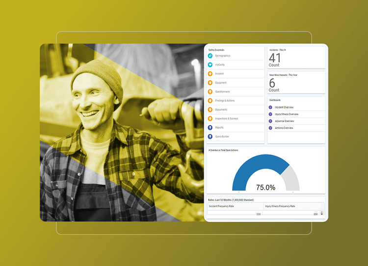 A man smiling at a computer screen, reviewing Behavior Based Safety data.